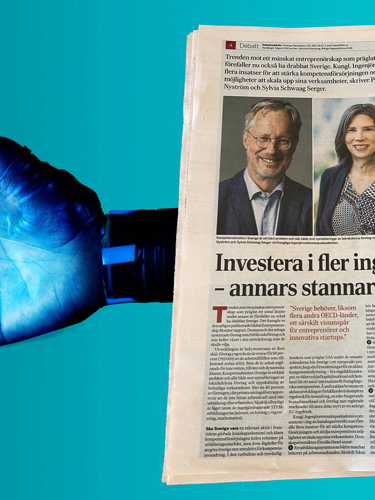robothand och papperstidning med tryckt debattartikel