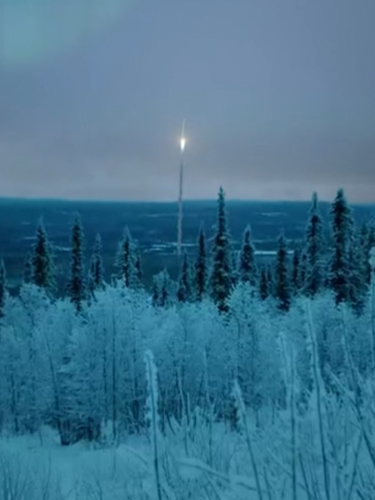 Satellit skjuter upp i ett vintrigt skogslandskap